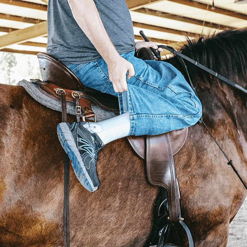 lower-limb-orthotics-wcbl9 man with prosthetic leg riding a horse