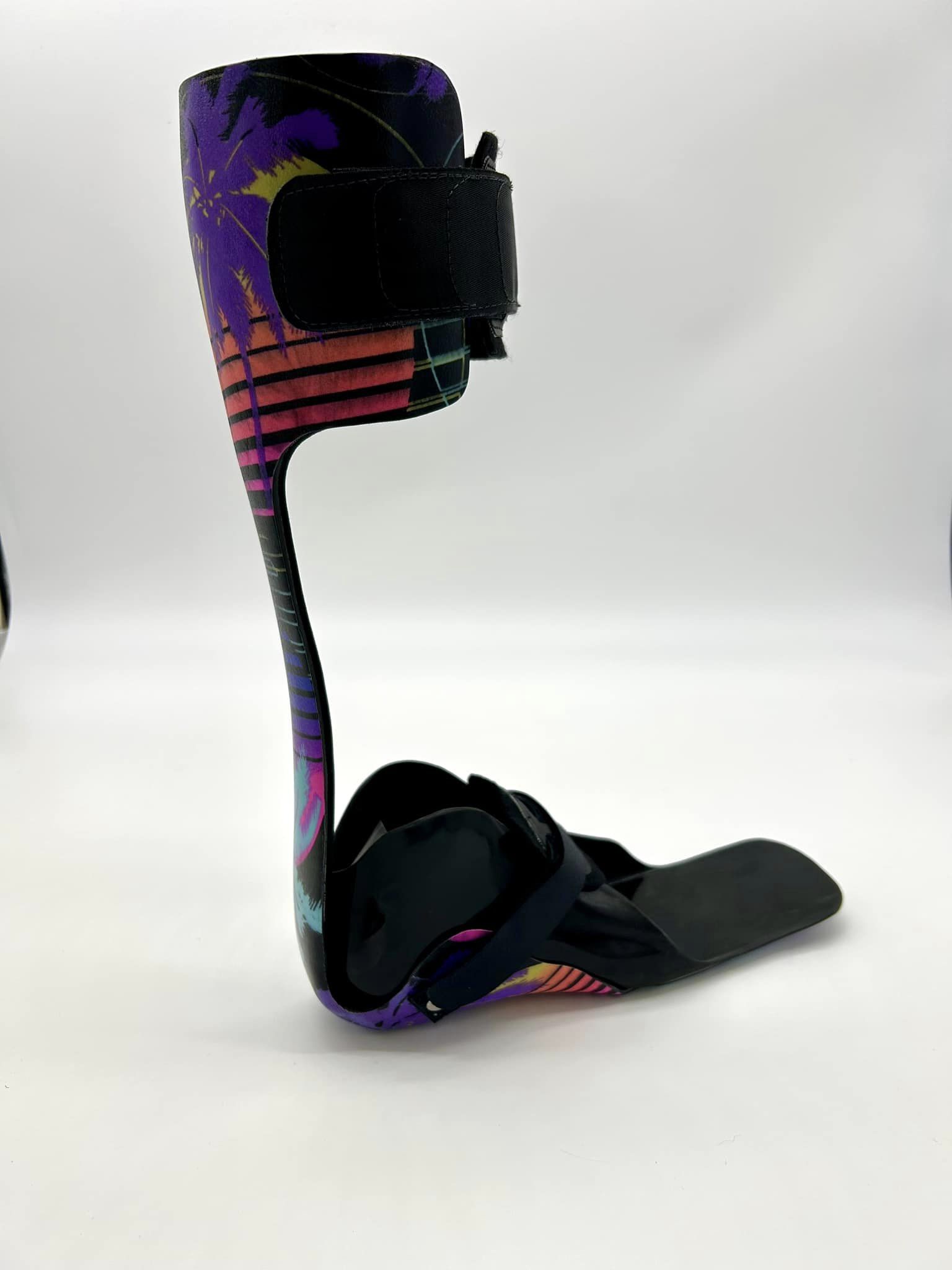 ankle foot orthosis brace with bright colors, palm trees and sun, in miami vice pattern