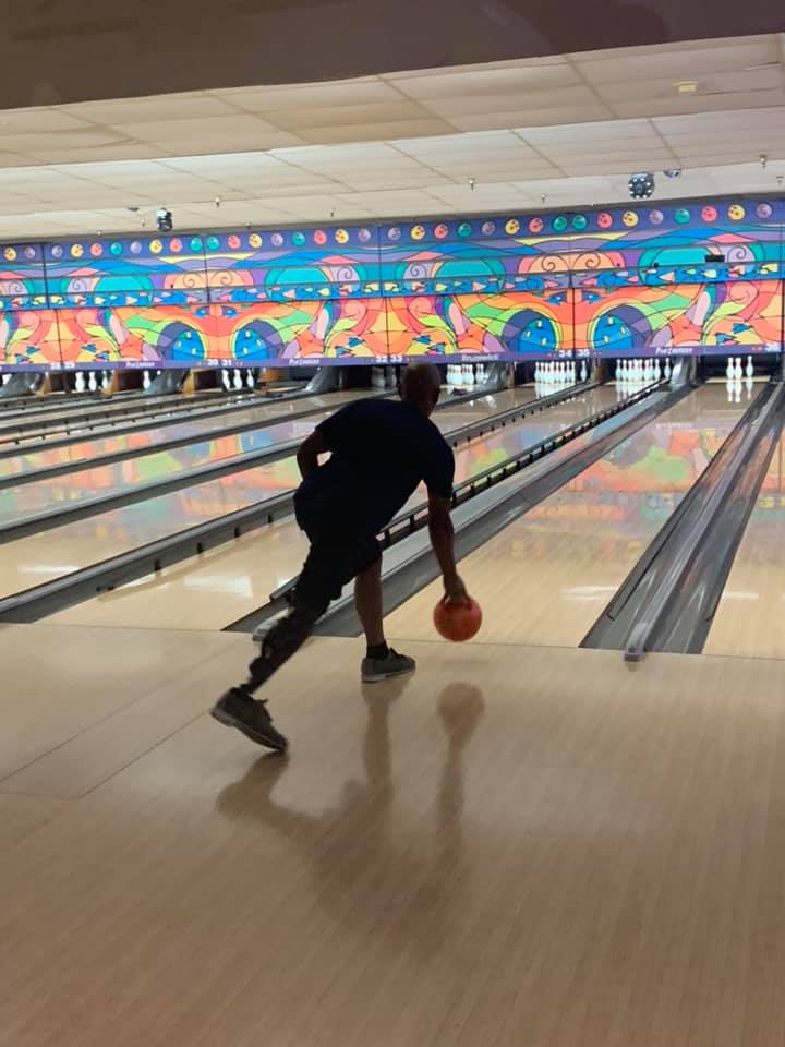 Bowling Amputee support Group without limits – daymon June 2021 Man with prosthetic leg bowling, about to release ball down bowling lane