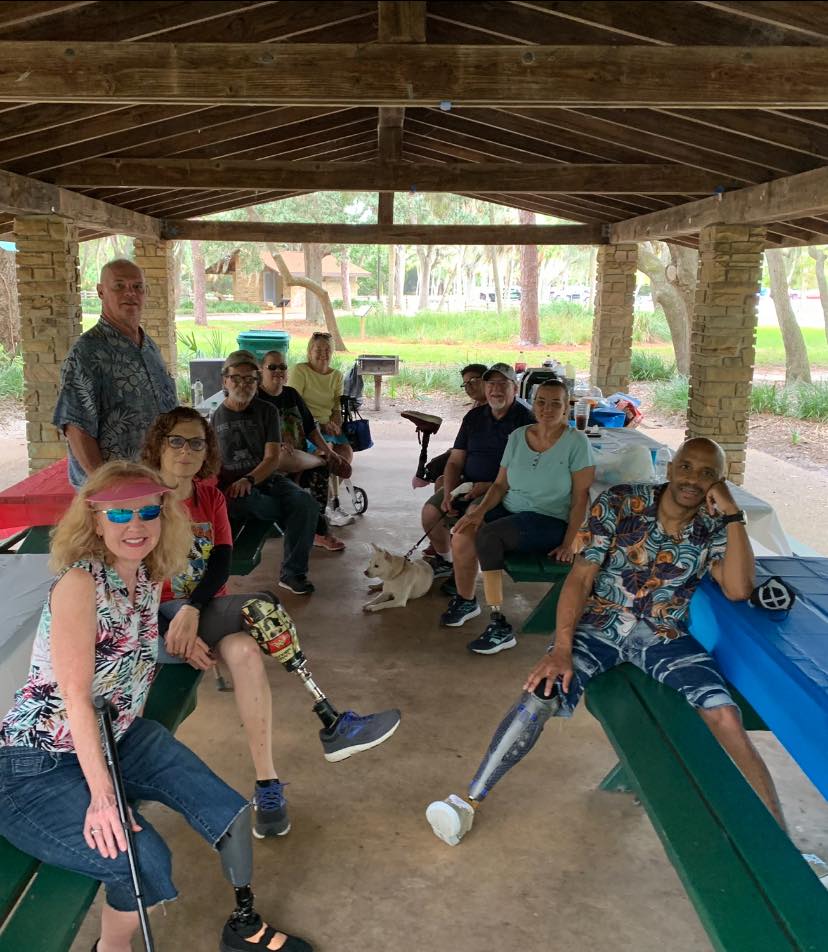 Without limits Adnerson Park Meet Up Nov 2020 Picnic Table at park shelter full of people smiling and gathered for amputee support group meet up